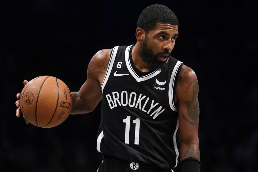 Brooklyn Nets guard Kyrie Irving (11) sets up a play during the second half of an NBA basketball game.