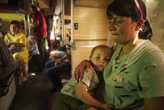 Alla hugs her son Ivan sitting in evacuation train in Pokrovsk, Donetsk region, Ukraine, Monday, August 19, 2024. Due to the advance of Russian troops to the west towards Myrograd, Alla and her son Ivan were forced to evacuate as volunteers. Intensive shelling forced people to leave homes. (AP Photo/Evgeniy Maloletka)