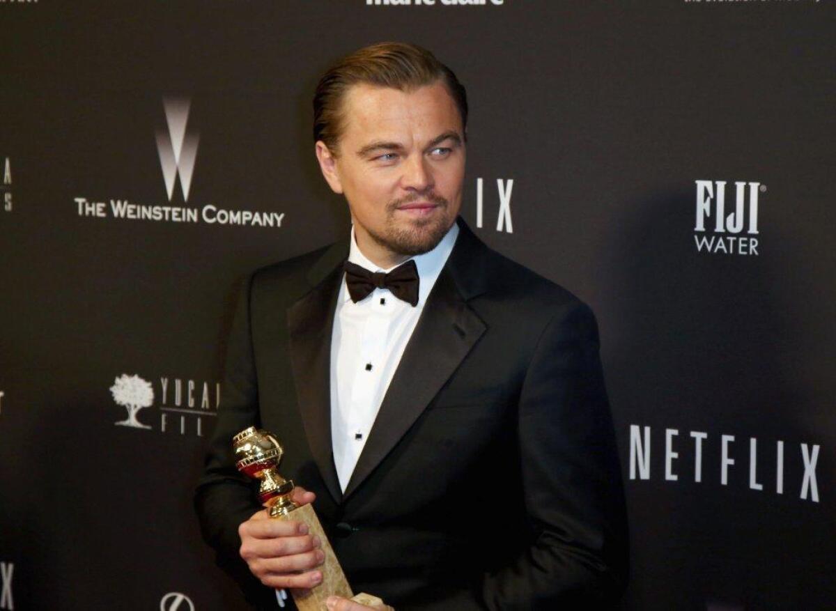 Leonardo DiCaprio holds his Golden Globe for lead actor in a motion picture comedy or musical for "The Wolf of Wall Street."