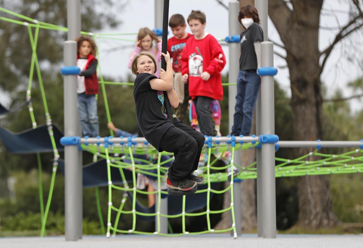 Kids test out the zip line at the new children's Central Park Playground in Huntington Beach.
