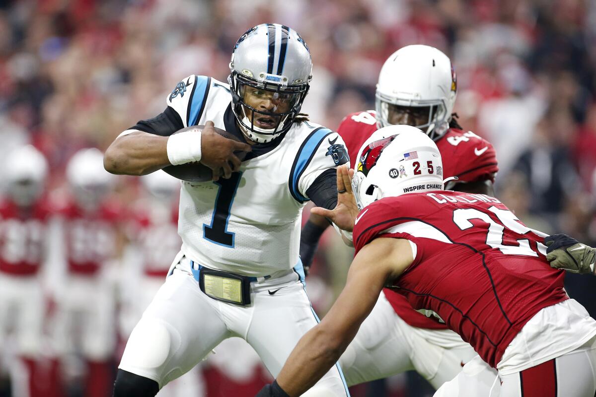 Carolina Panthers quarterback Cam Newton looks to avoid the tackle of Arizona Cardinals linebacker Zaven Collins.