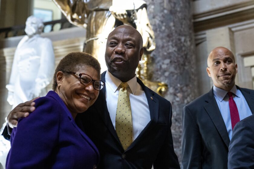 WASHINGTON, DC - MAY 18: (L-R) Rep. Karen Bass (D-CA), Sen. Tim Scott (R-SC), and Sen. Cory Booker (D-NJ) depart the office of Rep. James Clyburn (D-SC) following a meeting about police reform legislation on Capitol Hill May 18, 2021 in Washington, DC. President Joe Biden has called for Congress to pass a police reform bill by the May 25th anniversary of the killing of George Floyd by Minneapolis Police officer Derek Chauvin. Lawmakers are still discussing key provisions in the bill, including qualified immunity laws for law enforcement officers. (Photo by Drew Angerer/Getty Images)