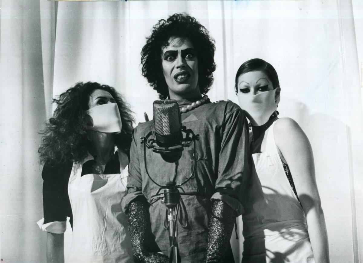 Frank N Furter (Tim Curry) announces the creation of Rocky with Magenta (Patricia Quinn) and Columbia (Little Nell) at his side in the cult-classic movie "The Rocky Horror Picture Show."