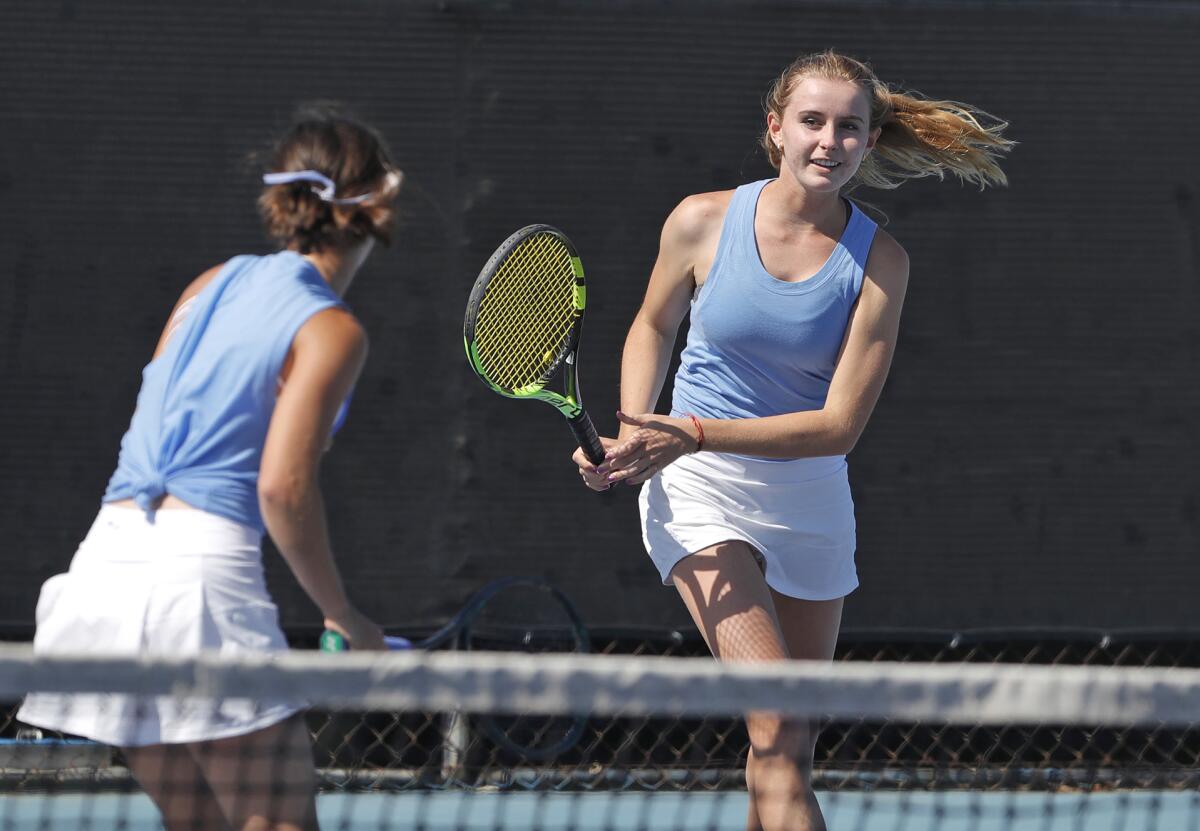 Corona del Mar's Alden Mulroy, right, celebrates a point with partner Sophia Andrei-Birca during Tuesday's match.