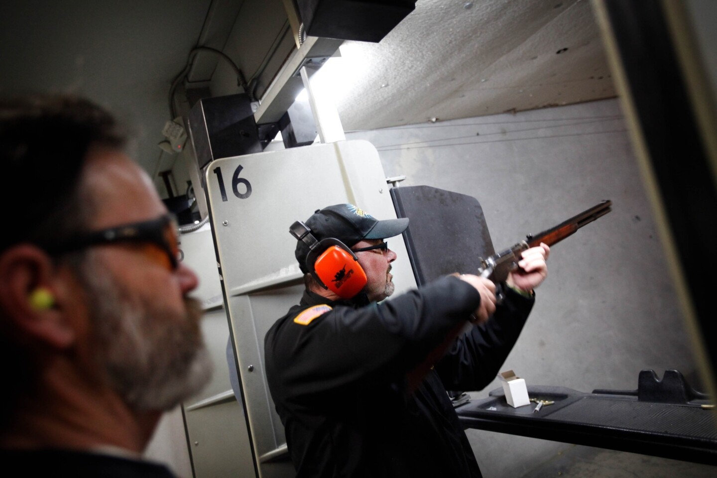Tim Donnelly aims a Glock 19 at a paper target at a gun range in Watsonville.