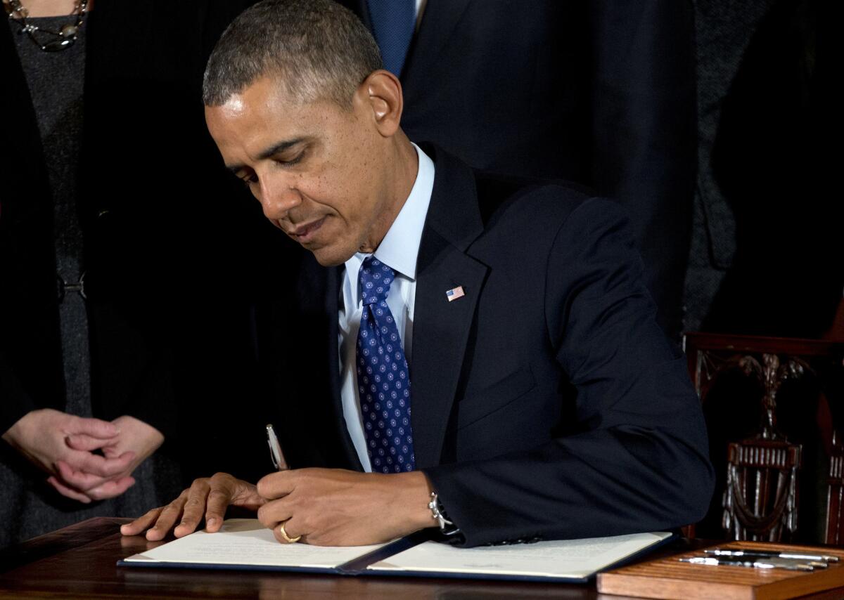 President Obama signs a memorandum creating a task force to respond to campus rapes during an event for the Council on Women and Girls.