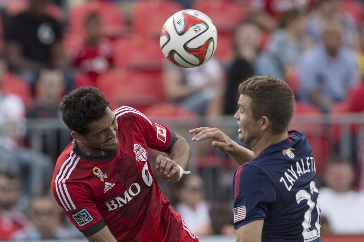 Toronto FC's Gilberto heads the ball away from Chivas USA's Eriq Zavaleta during the second half. Gilberto also scored a goal in the 54th minute.