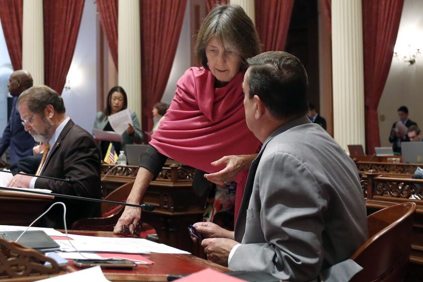 State Sen. Nancy Skinner, D-Berkeley, talks with Sen. Joel Anderson, R-Alpine, during the Senate session, Tuesday, Aug. 28, 2018, in Sacramento, Calif. The Assembly approved Skinner's bill limiting the state's "felony murder" rule that allows accomplices to face execution or life sentences even if they didn't personally kill someone. It now goes to the Senate for a final vote. (AP Photo/Rich Pedroncelli)