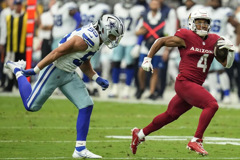 Arizona Cardinals wide receiver Rondale Moore (4) runs for a touchdown against Dallas Cowboys linebacker Leighton Vander Esch (55) during the first half of an NFL football game, Sunday, Sept. 24, 2023, in Glendale, Ariz. (AP Photo/Ross D. Franklin)