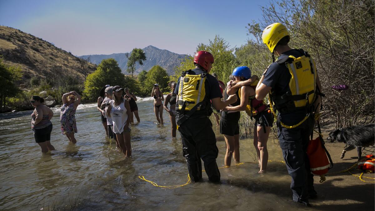 Shannon Gilbert, second from right, gets a hug after being rescued. She was tubing without a life vest.