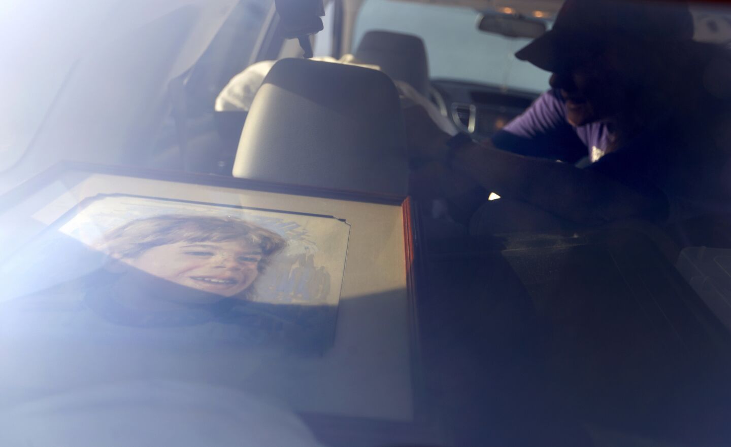 Paula Baker packs her car as a photo of her late son Ray Bryan, who died 11 years ago, sits in the trunk, as she evacuates her home in Atlantic Beach, N.C., Wednesday, Sept. 12, 2018, as Hurricane Florence approaches the east coast.