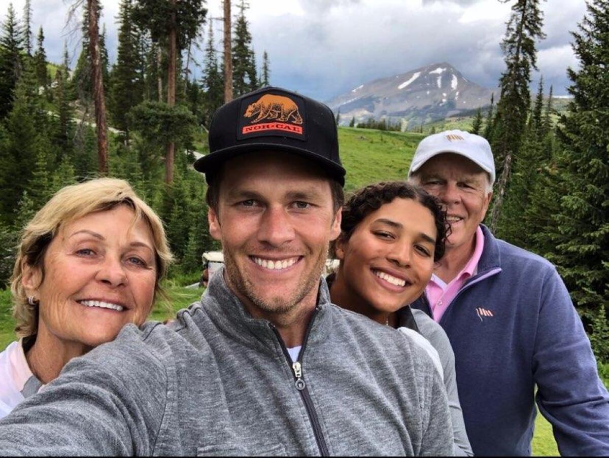 Tampa Bay Bucaneers quarterback Tom Brady (center) takes a photo with his niece Maya Brady and parents Galynn and Tom Sr. 