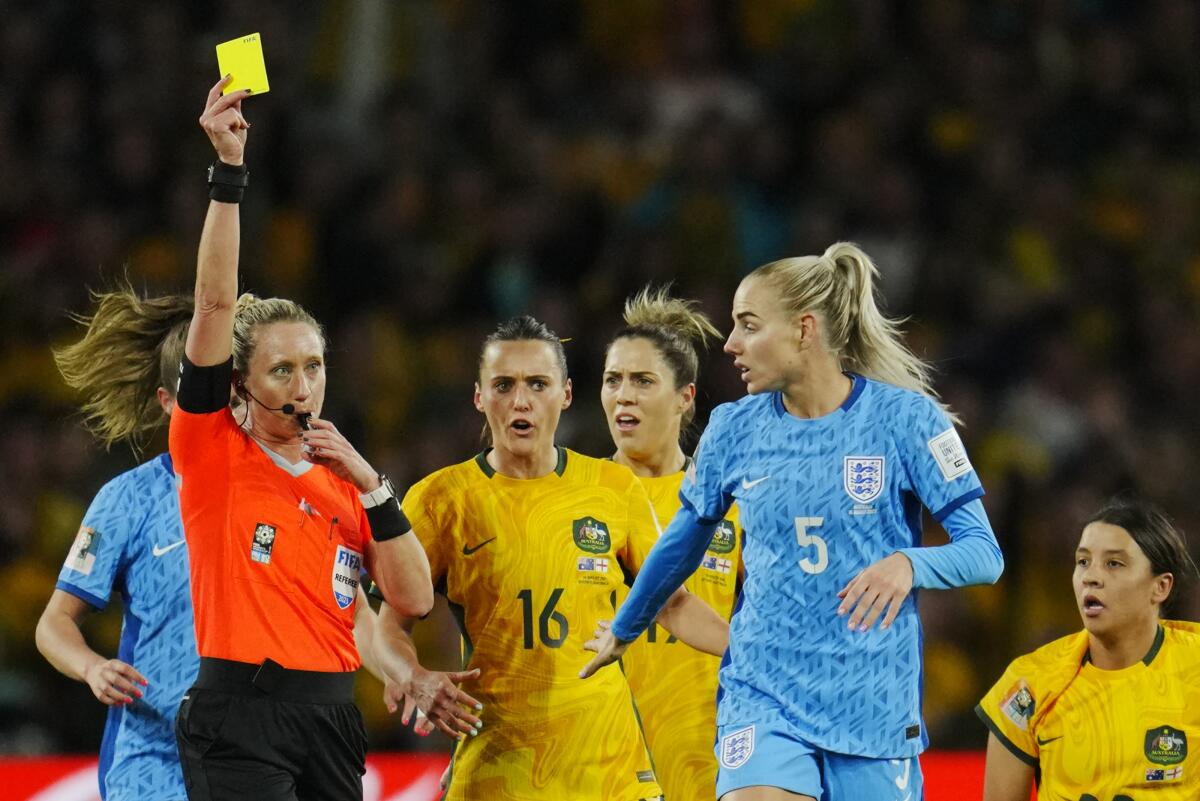 Referee Tori Penso shows a yellow card to England's Alex Greenwood during a Women's World Cup semifinal match.