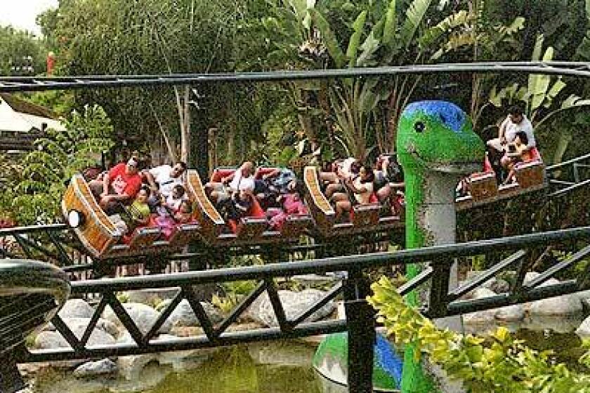 The Coastersaurus circles a dinosaur crafted from Lego bricks. The junior roller coaster is in a new dinosaur-themed area of Legoland.