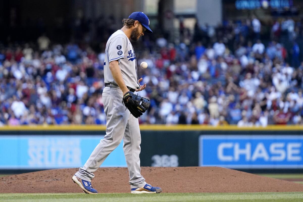 The Dodgers' Clayton Kershaw flips a new baseball after giving up a second-inning homer to the Diamondbacks' Carson Kelly.