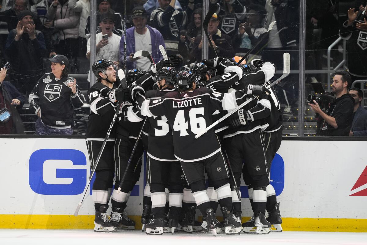 Kings players celebrate an overtime goal by Vladislav Gavrikov at Crypto.com Arena.