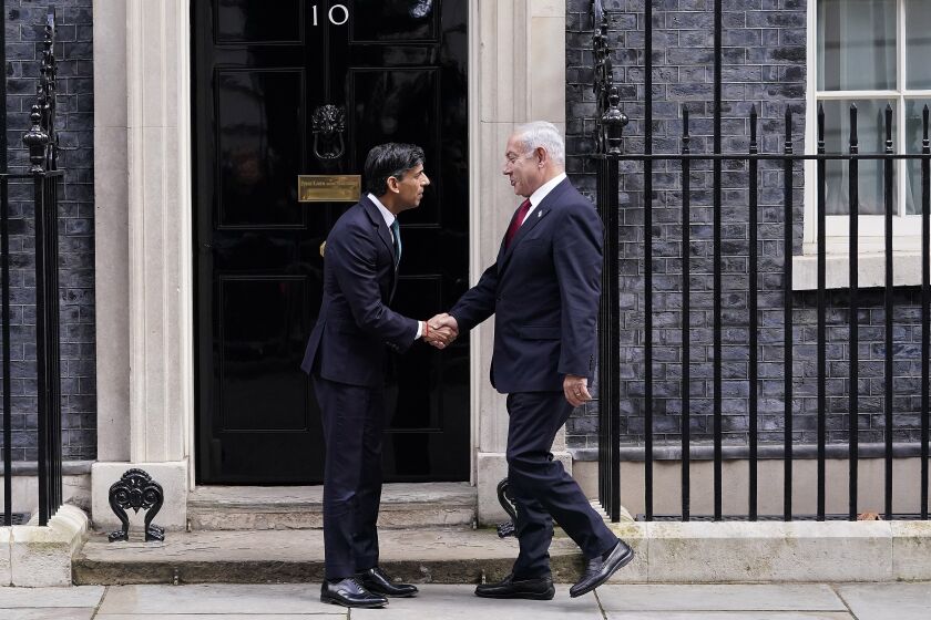 Britain's Prime Minister Rishi Sunak, left, welcomes Israel Prime Minister Benjamin Netanyahu at Downing Street in London, Friday, March 24, 2023.(AP Photo/Alberto Pezzali)