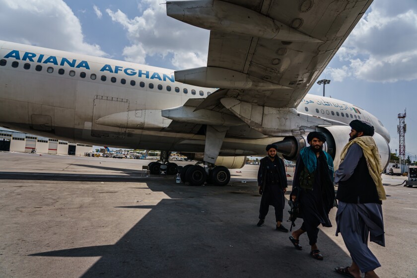 Taliban fighters patrol Kabul's airport on Aug. 31 after the U.S. military finished its withdrawal.