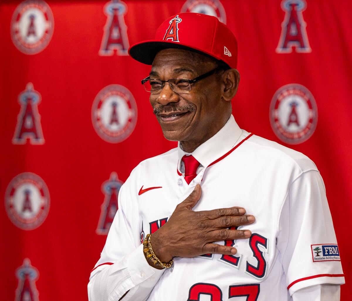 Angels manager Ron Washington places his hand over his heart during an introductory news conference.