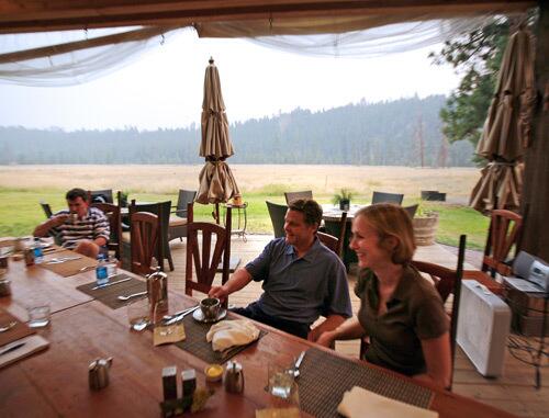 Greg Bondick, left, of Carlisle, Mass., and Rhyne and Lisa Davis of Charlotte, N.C., enjoy coffee and conversation at The Resort at Paws Up, a 37,000-acre getaway in Montana. The resort is for affluent travelers who want to enjoy the outdoors but cant fathom using an outhouse.
