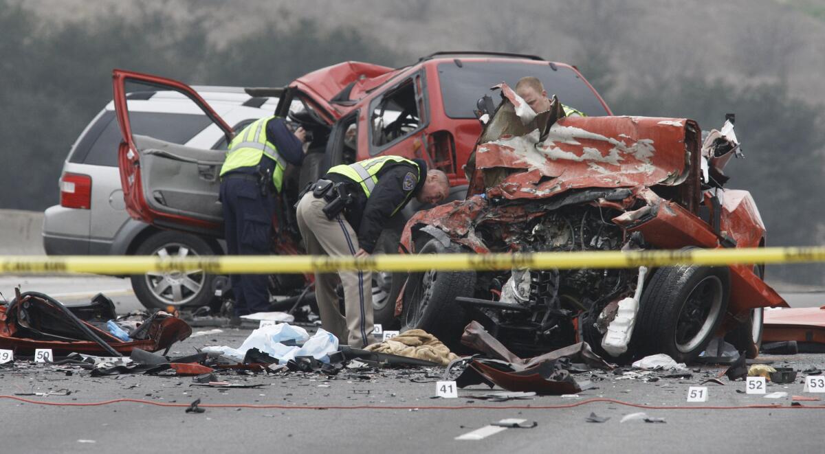 Officers examine the wreckage of a 2014 fatal car crash blamed on DUI.