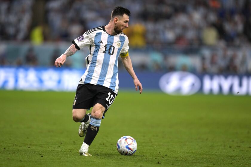 Argentina's Lionel Messi dribbles the ball during the World Cup round of 16 soccer match between Argentina and Australia at the Ahmad Bin Ali Stadium in Doha, Qatar, Saturday, Dec. 3, 2022. (AP Photo/Frank Augstein)