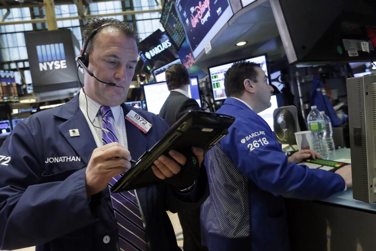 Trader Jonathan Corpina, left, works on the floor of the New York Stock Exchange on Feb. 1.
