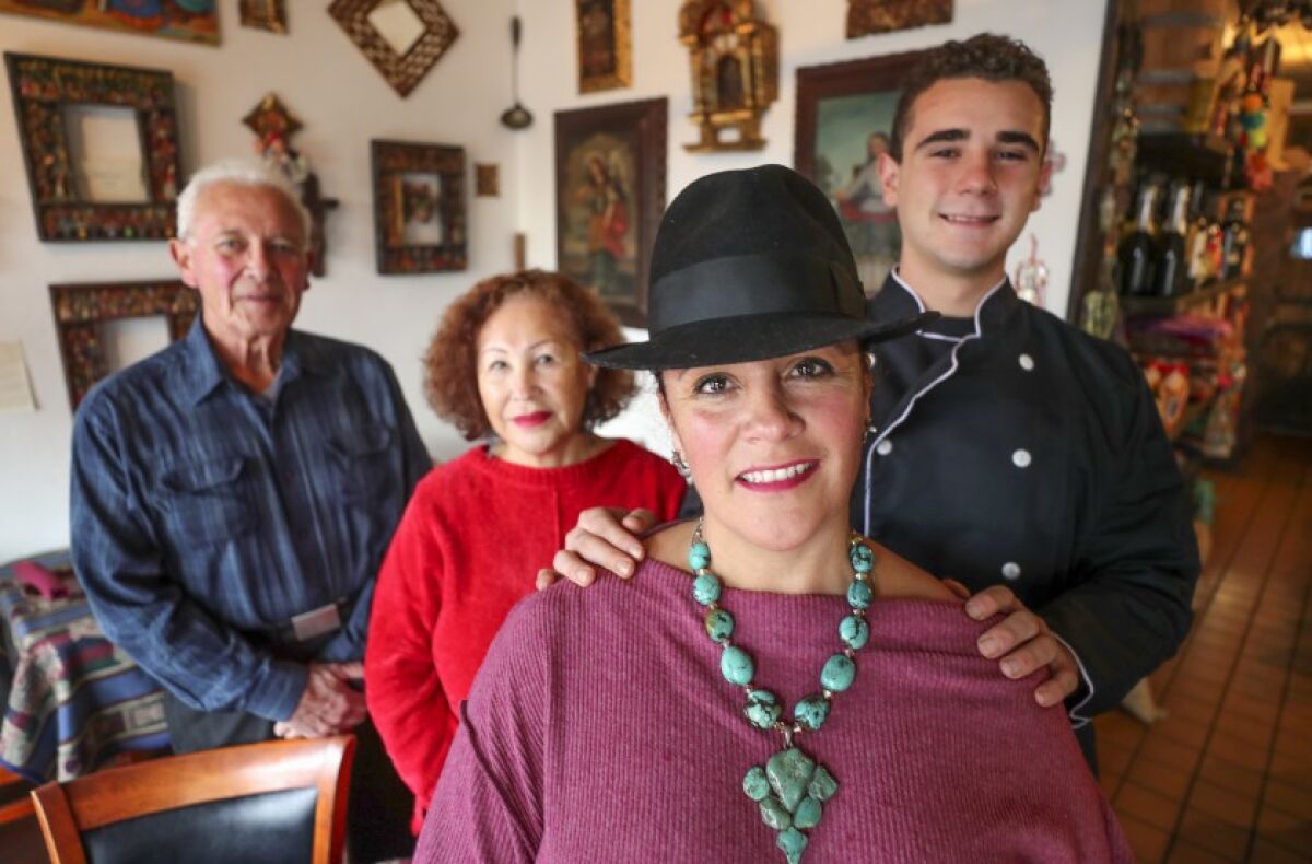 Q’ero restaurant owner Monica Szepesy, foreground, with her son Niko Szepesy Ortega, 18, and her parents Gene and Carmen Szepesy inside the Peruvian restaurant in Encinitas on Wednesday, Nov. 27.