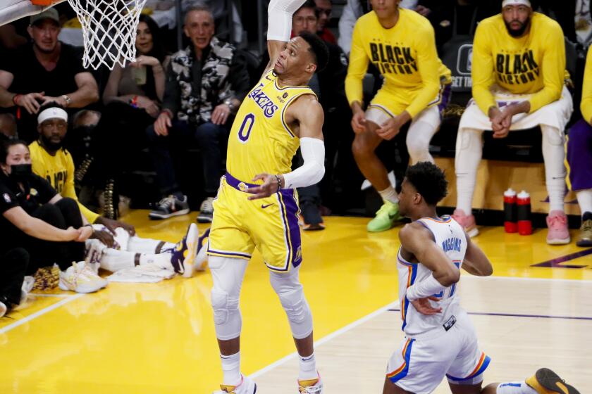 LOS ANGELES, CA - FEBRUARY 07: Los Angeles Lakers guard Russell Westbrook (0) dunks the ball ahead of Oklahoma City Thunder guard Aaron Wiggins (21) during the second quarter at Crypto.com Arena on Tuesday, Feb. 7, 2023 in Los Angeles, CA.(Robert Gauthier / Los Angeles Times)
