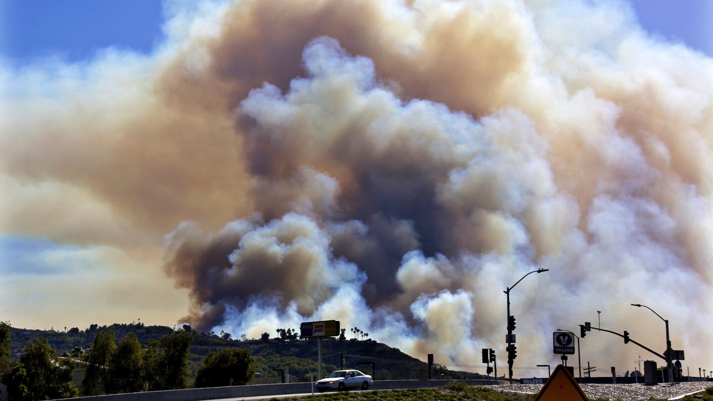 Fire burns above the hills in San Marcos. Multiple brush fires are burning in the San Diego area.