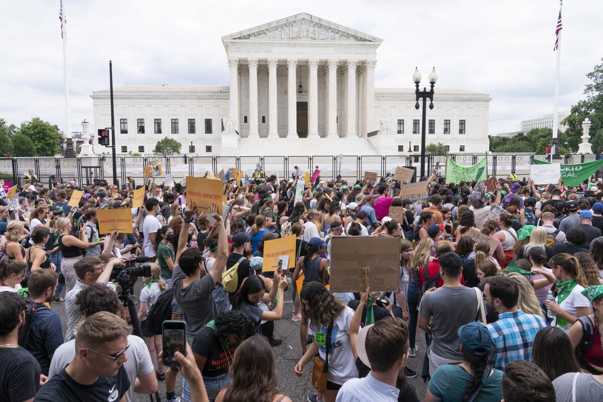 Protesters gather outside the Supreme Court Friday.