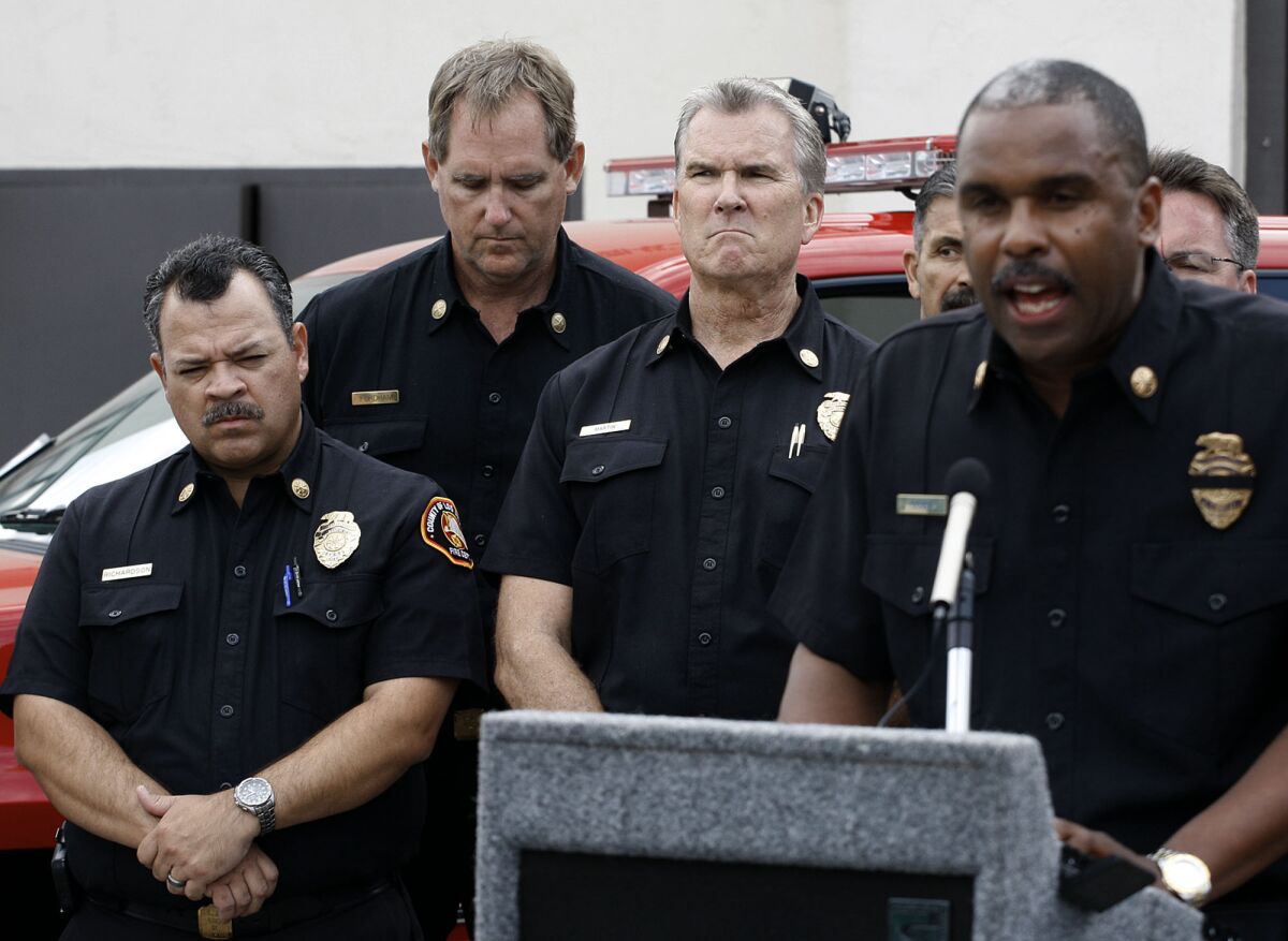 L.A. County Fire Chief Daryl Osby, right, talks about Kevin Woyjeck during a news conference last week.