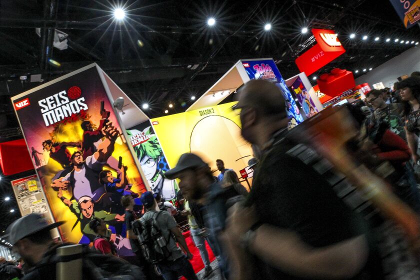 People pass by booths during Comic-Con International at the San Diego Convention Center on Saturday, July 20, 2019 in San Diego, California.
