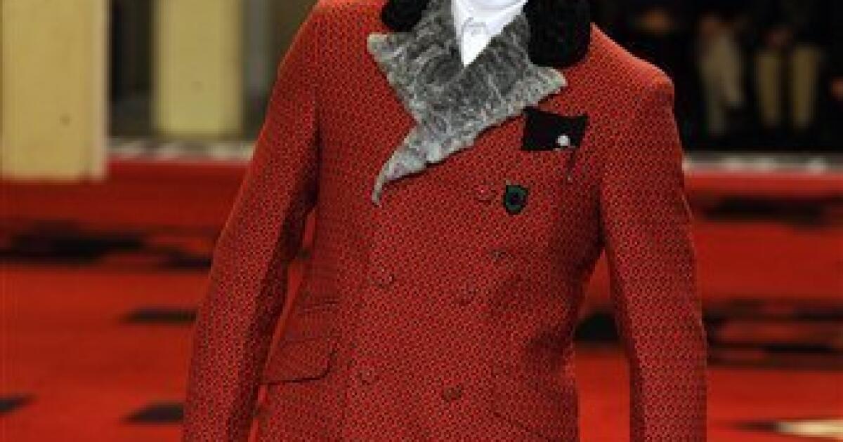 MILAN - JANUARY 15: Man with red tartan coat and Louis Vuitton