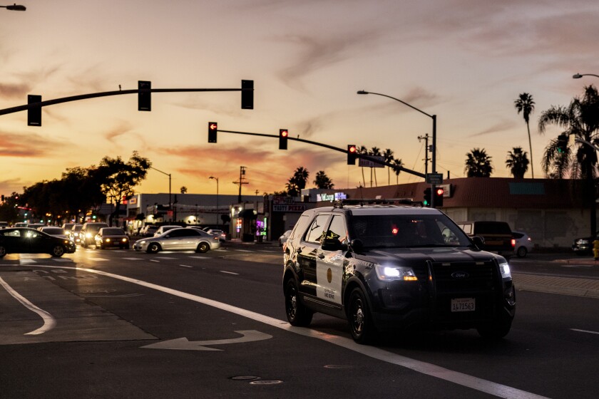 A San Diego Police Department vehicle patrols at sunset