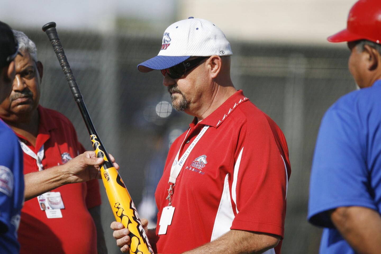 Puerto Rico talk to officials as they say Arroyo Seco is using an illegal bat during the game, which took place at Major League Baseball Urban Youth Academy in Compton on Thursday, August 3, 2012.