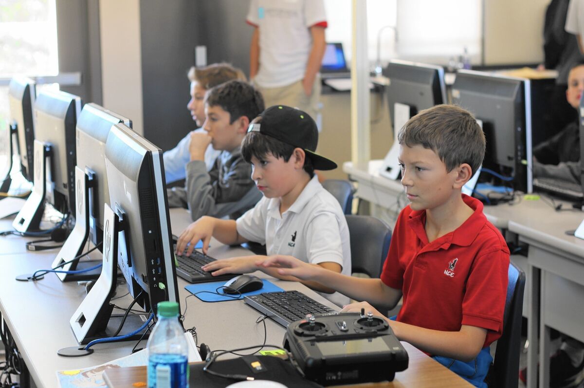 Students at Newport Coast Elementary School work on computer coding after school in 2016.