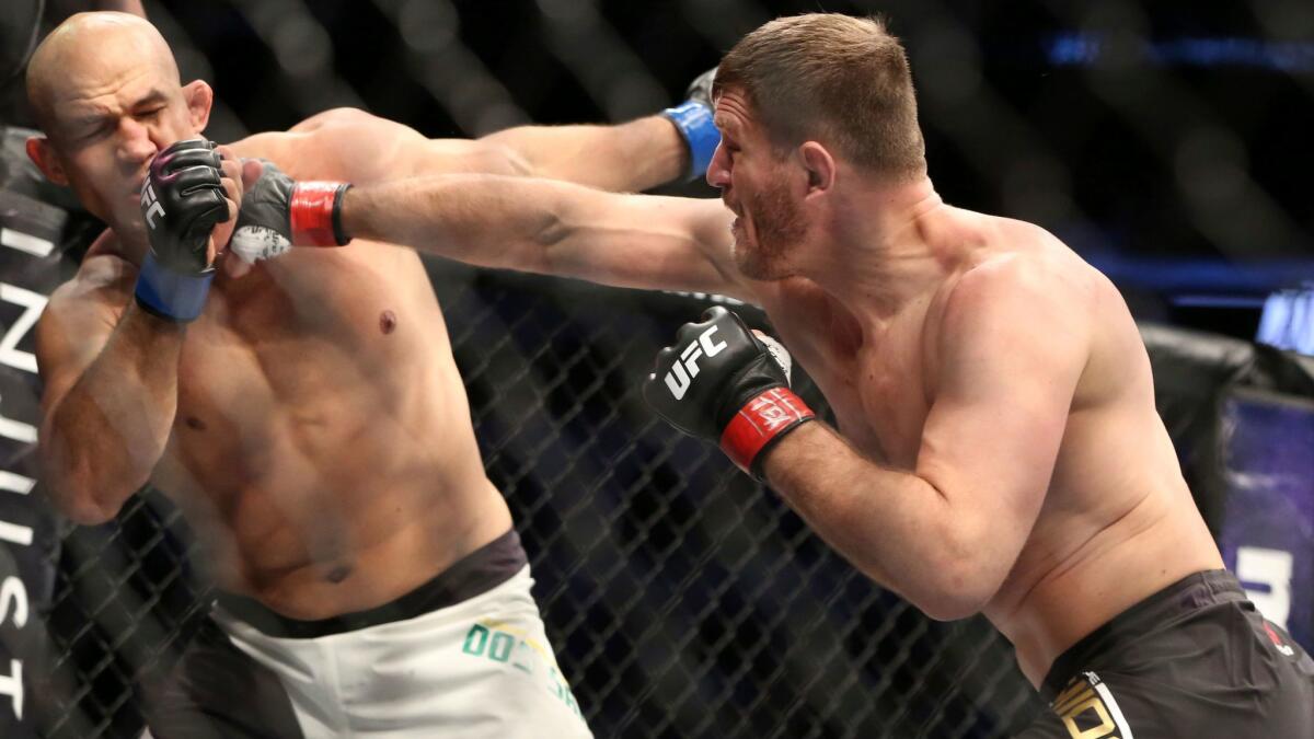 Stipe Miocic lands a right against Junior Dos Santos at UFC 211 in Dallas on May 13.