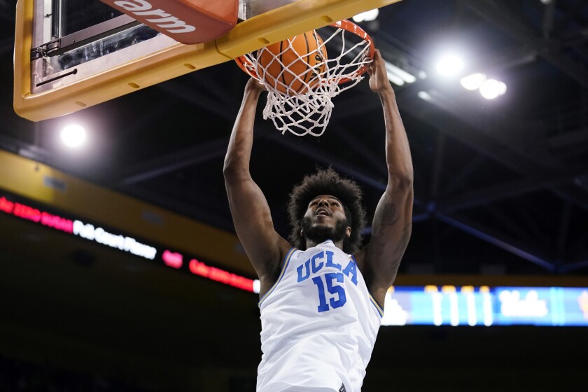 UCLA center Myles Johnson dunks during the first half against Arizona State.