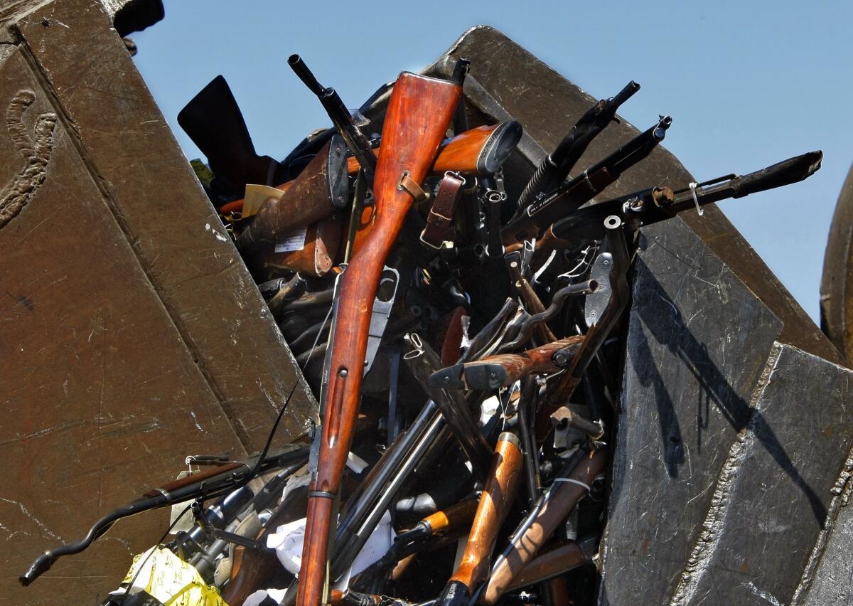 Front loaders scoop up some of thousands of confiscated firearms destroyed each year.
