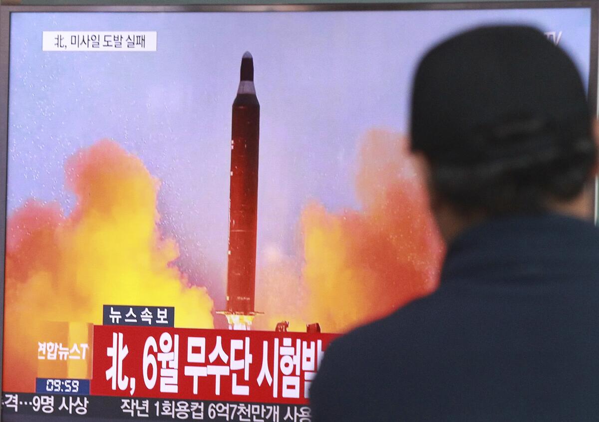 In this Oct. 16, 2016, photo, a man at a South Korean railway station watches a TV news program showing a file image of a missile launch conducted by North Korea.