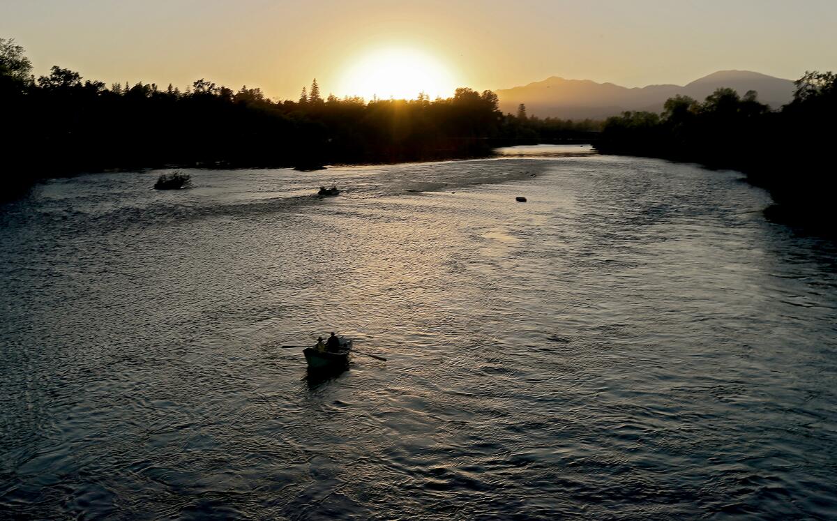 Fishermen ply the waters of the Sacramento River near Redding in October. 