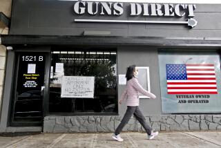 A walker passes by Guns Direct on the 500 block of W. Magnolia Blvd.., where services are only by appointment, in Burbank on Wednesday, April 8, 2020.
