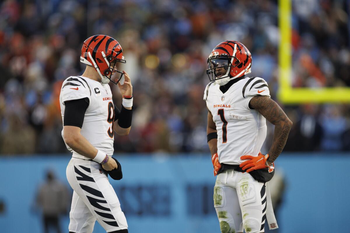 Bengals quarterback Joe Burrow and wide receiver Ja'Marr Chase walk onto the field.