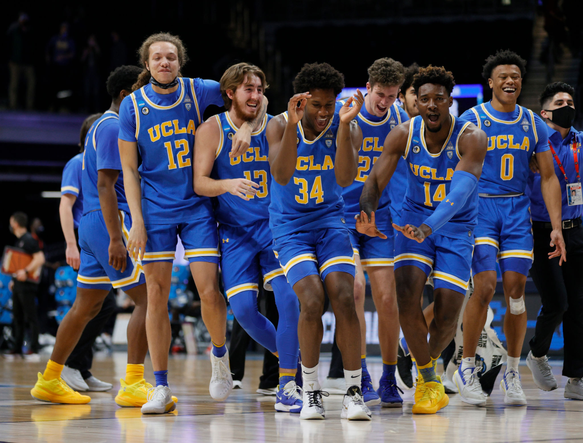 UCLA players, including David Singleton (34), exult after defeating Alabama in the Sweet 16.