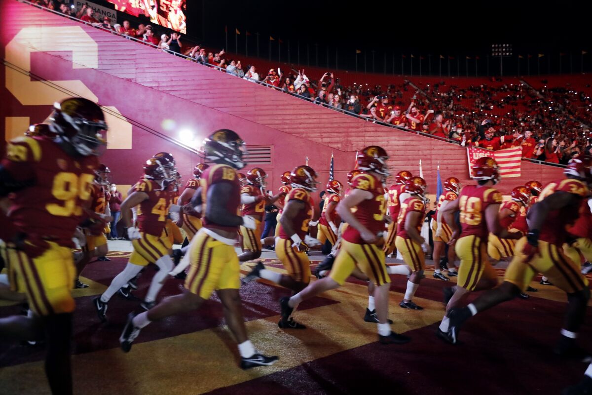 USC players run out of the tunnel before a game against Oregon State on Sept. 25.