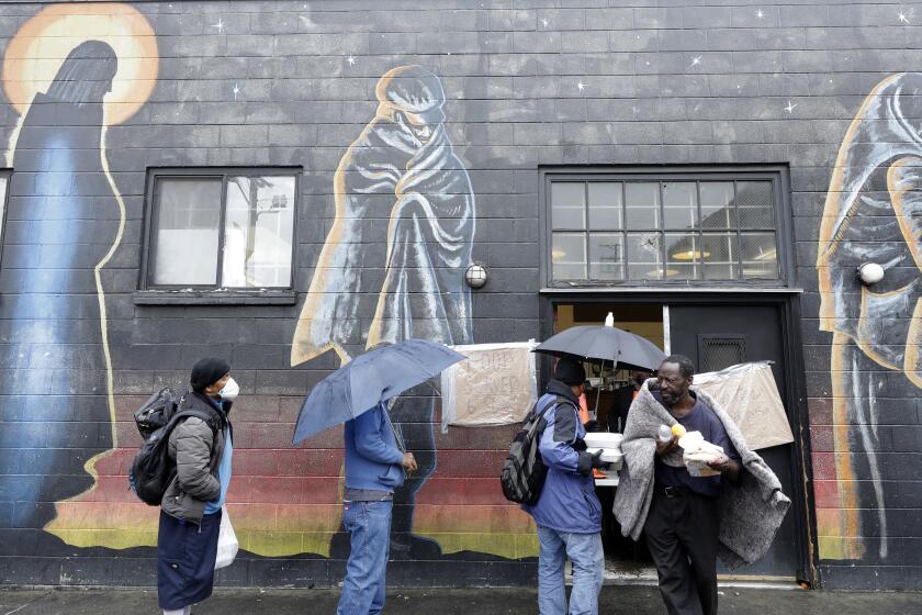 LOS ANGELES, CA - APRIL 09: Hippie Kitchen in Los Angeles hands out food, water and toiletries to the homeless and residents of skid row. Additionally, masks were offered to help reduce the spread of the coronavirus among the homeless. (Myung J. Chun / Los Angeles Times)