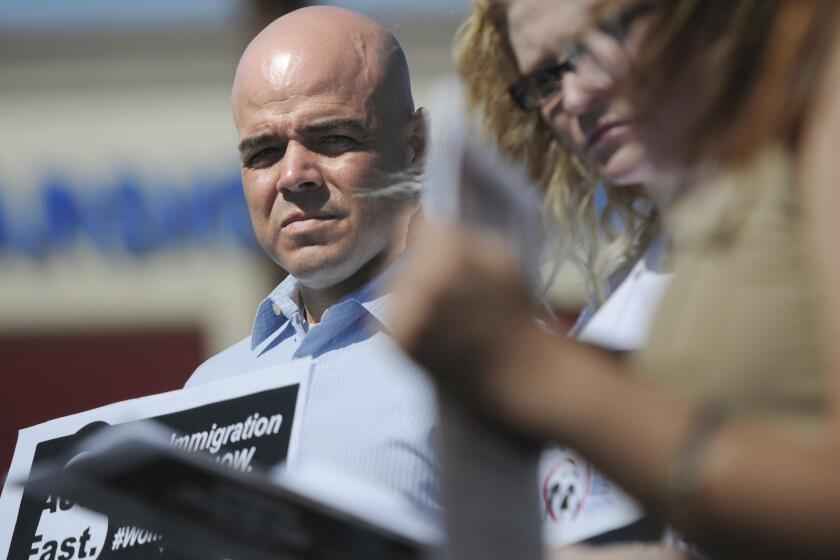 In this March 24, 2014, file photo, Immigration Reform for Nevada supporter Robert Telles is seen during an event outside the office of U.S. Rep. Joe Heck, R-Nev., in protest of Congress not taking action on comprehensive immigration reform. Police say they are serving search warrants in connection with the fatal stabbing of a Las Vegas newspaper reporter last week. In a statement Wednesday, Sept. 7, 2022 Metro Police didn’t specify where they were searching in connection with the death of reporter Jeff German. But the Las Vegas Review-Journal reported uniformed officers and police vehicles were seen outside the home of Clark County Public Administrator Robert Telles (Erik Verduzco/Las Vegas Review-Journal via AP)