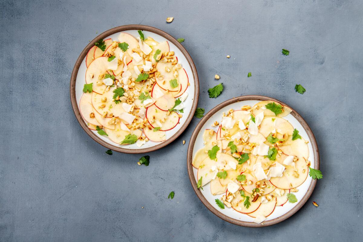 Sweet-tart fall apples make a great salad when shaved and mixed with lime juice, Parmigiano-Reggiano and peanuts for a new autumn classic. Prop styling by Nidia Cueva.