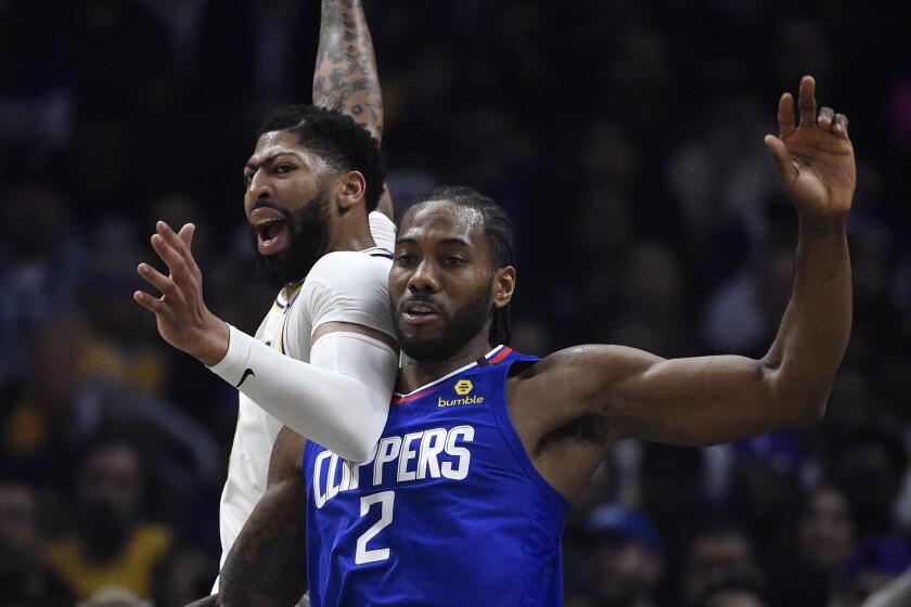 All-Star forwards Anthony Davis, left, and Kawhi Leonard fight for position during a game March 8, 2020.